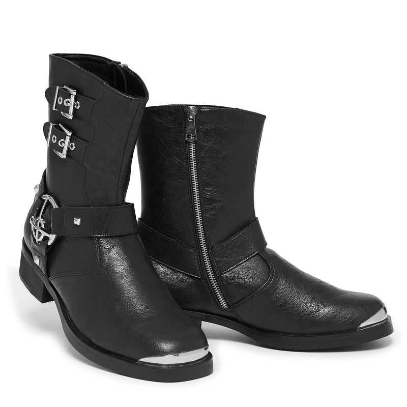 Black leather boots with silver buckles and zippers on a white background