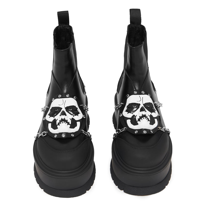 Black boots with skull designs and chain details on a white background