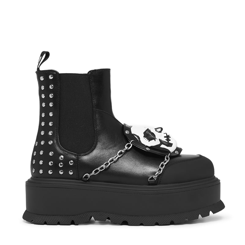 Black platform boot with studs, chain, and skull design on a white background