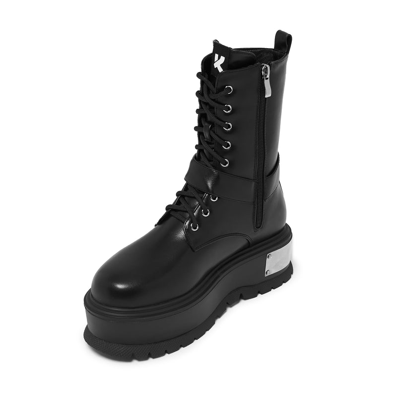 Black combat boot with a thick sole on a white background