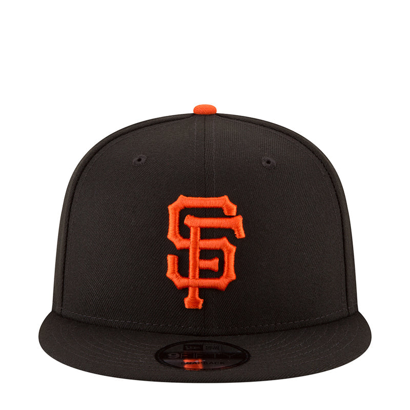 Black baseball cap with orange SF logo on front and orange top button