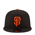Black baseball cap with orange SF logo on front and orange top button