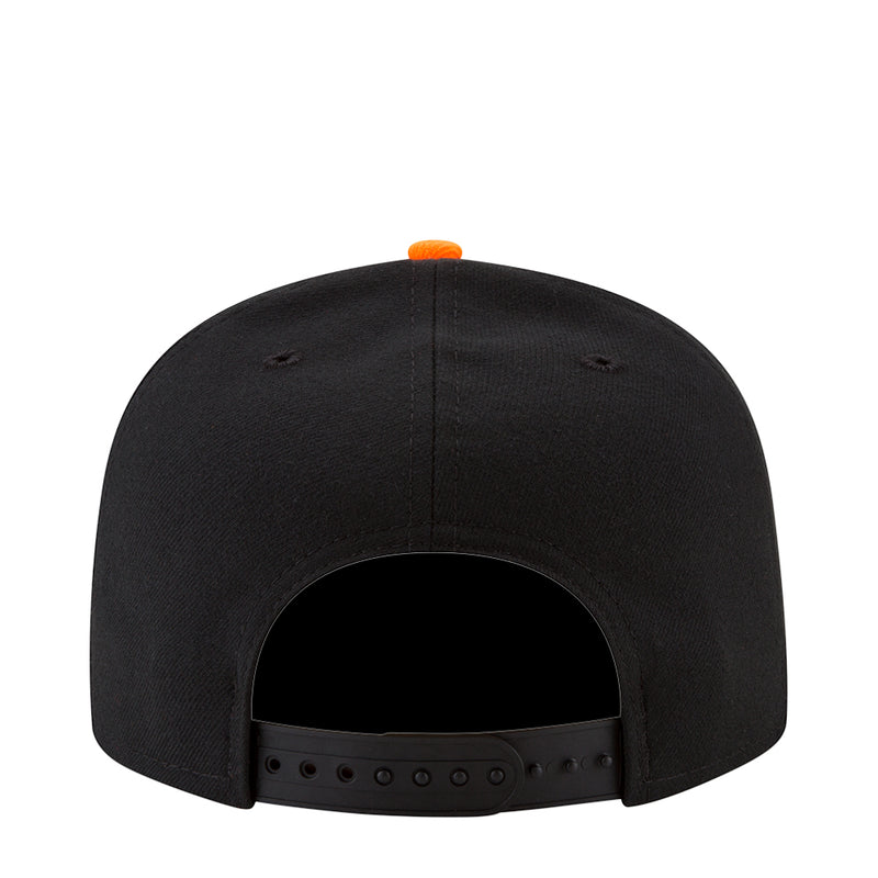 Black baseball cap back view with orange top button and fabric eyelets on strap