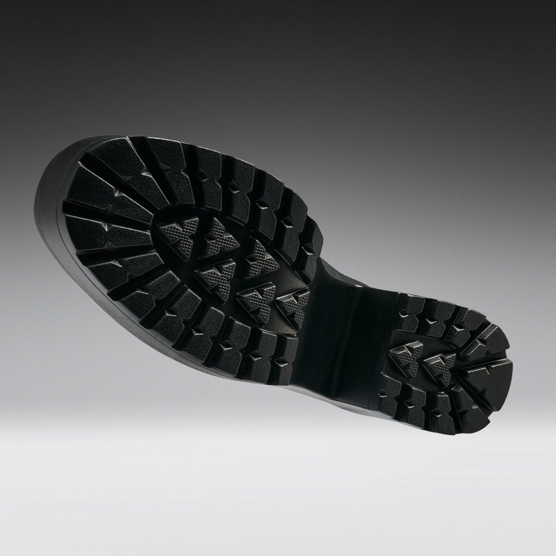 Close-up of a black rubber sole on a gray background