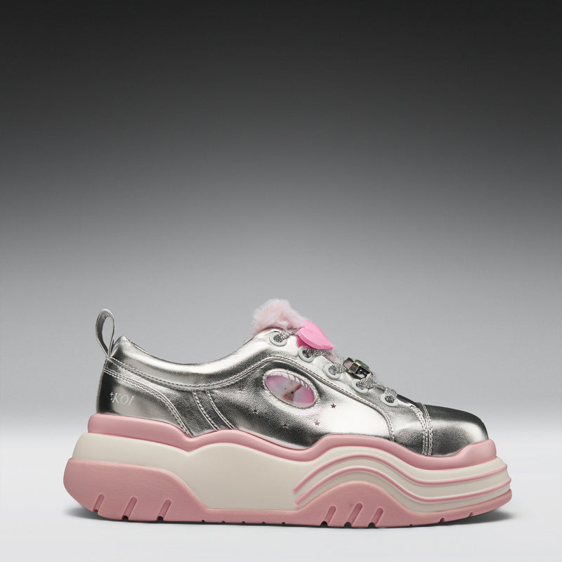 Silver sneaker with pink sole and accents on a gray background