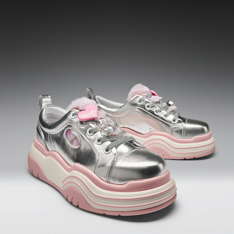 Silver and pink sneakers with a platform sole on a gray background
