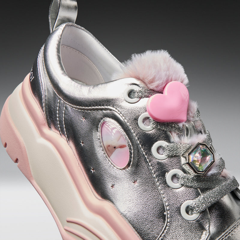 Silver sneaker with pink heart and fur details on a gray background