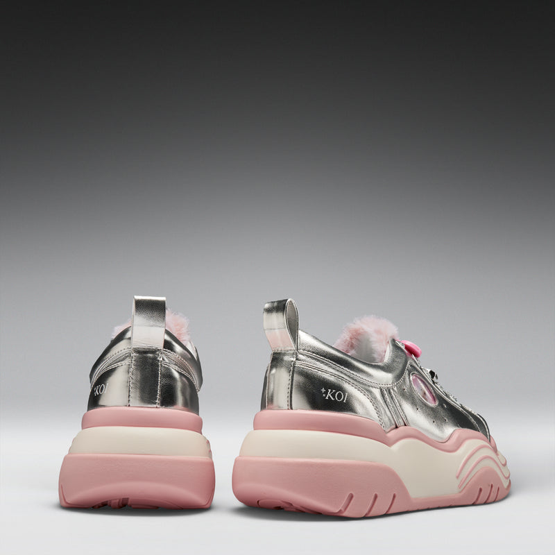 Pair of pink and silver sneakers on a gray background