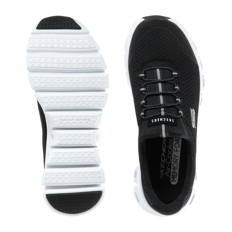 Black and white women's sneaker outsole with tread and lace-up upper view