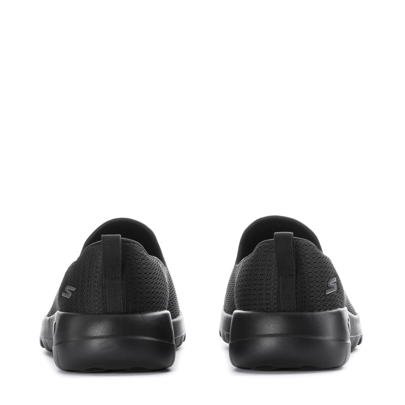 Women's black slip-on walking shoes, heel view with logo detail on back