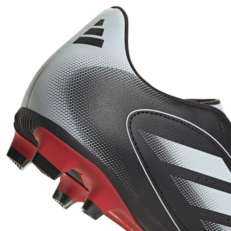 Men's white and black soccer cleats with red studded sole