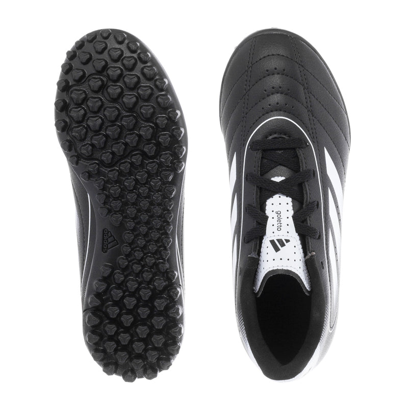Kids black and white soccer cleats: textured outsole studs and lace-up upper