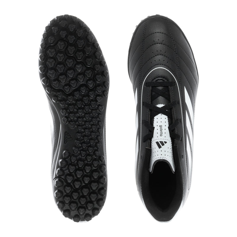 Youth black turf soccer cleat outsole and heel view with textured stud pattern