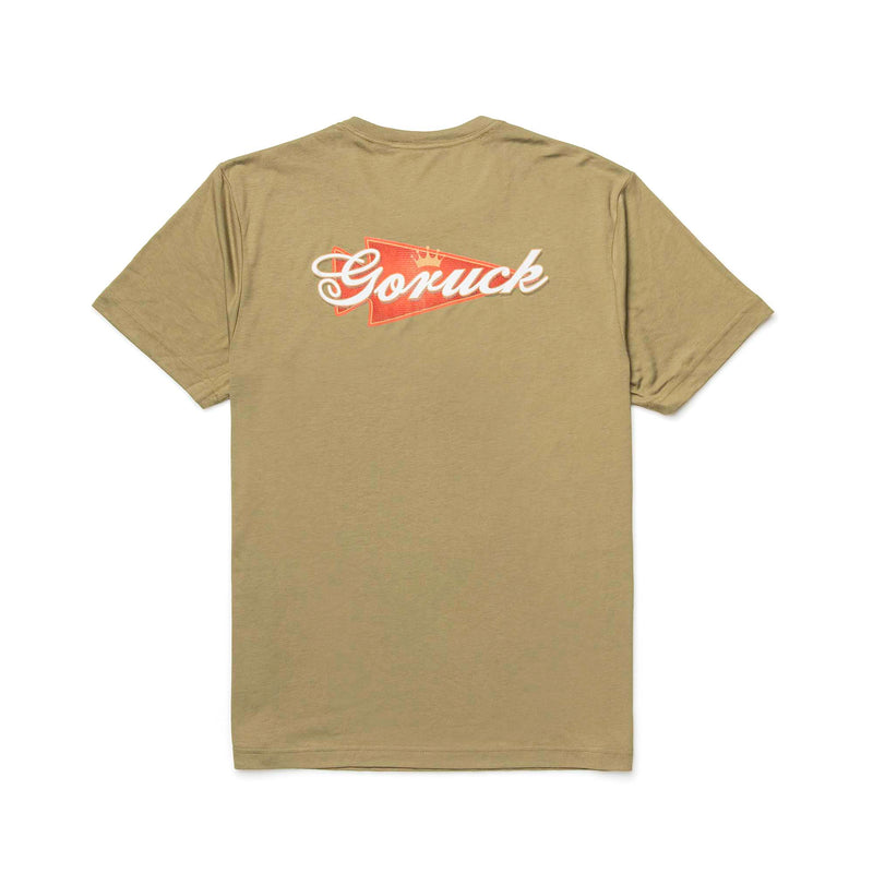 The GORUCK Bud Tee - Tri-Blend is a khaki premium shirt with a red and white "Goruck" logo on the upper back, ideal for everyday wear.