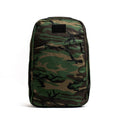 The GR1 USA - Heritage Woodland Camo M81 pack features a rectangular design with a green and brown M81 pattern on white, enhanced by full-grain leather handles for durability and style.