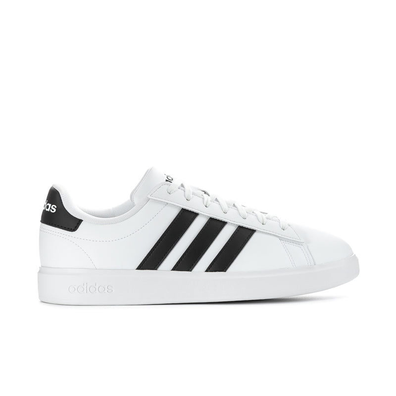 Men's white leather low-top sneakers with black adidas heel patch and three stripes
