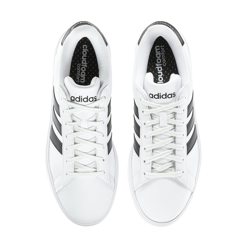 Men's white low-top sneakers with black lining and adidas tongue logo