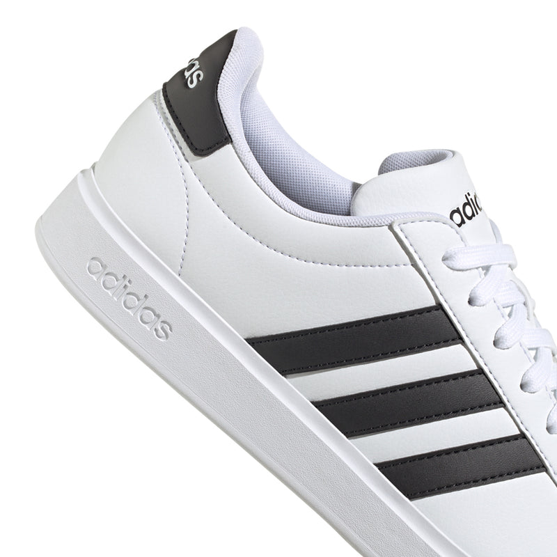 Men's white low-top sneakers with black stripe panel and adidas side logo
