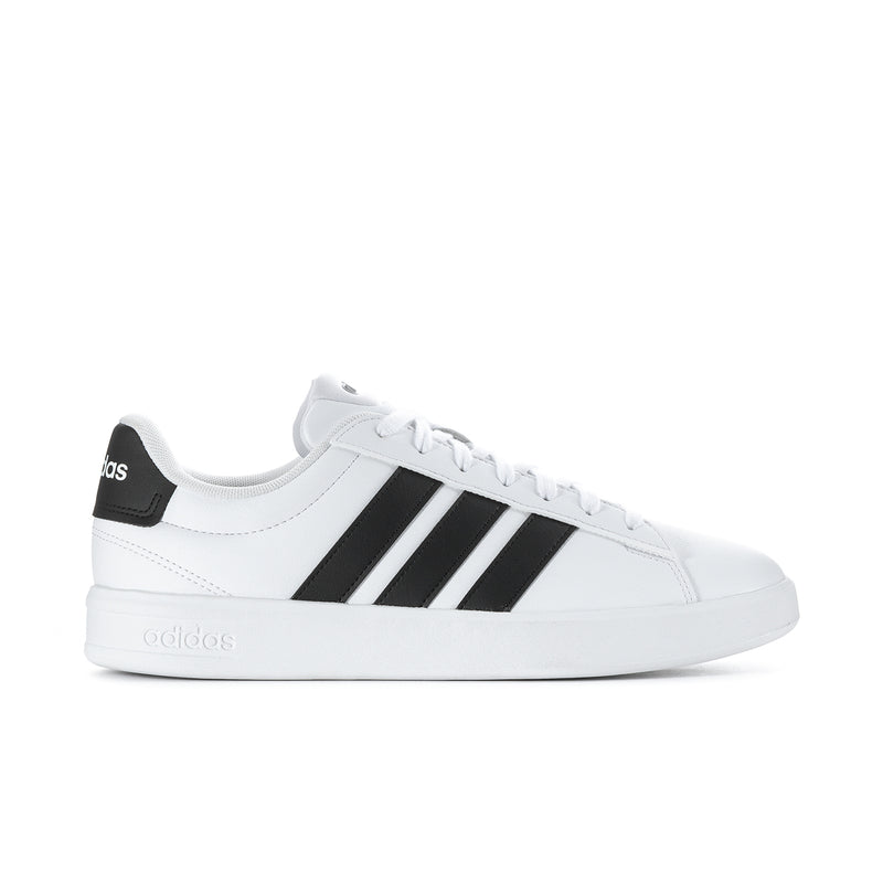 Men's white leather low-top sneakers with black adidas stripes and lace-up