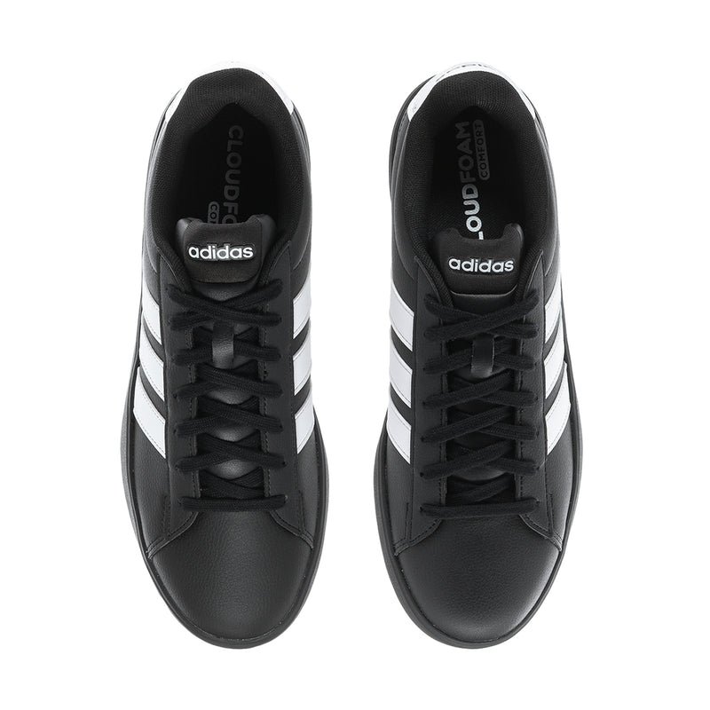 Pair of black adidas sneakers with black laces and white side stripes