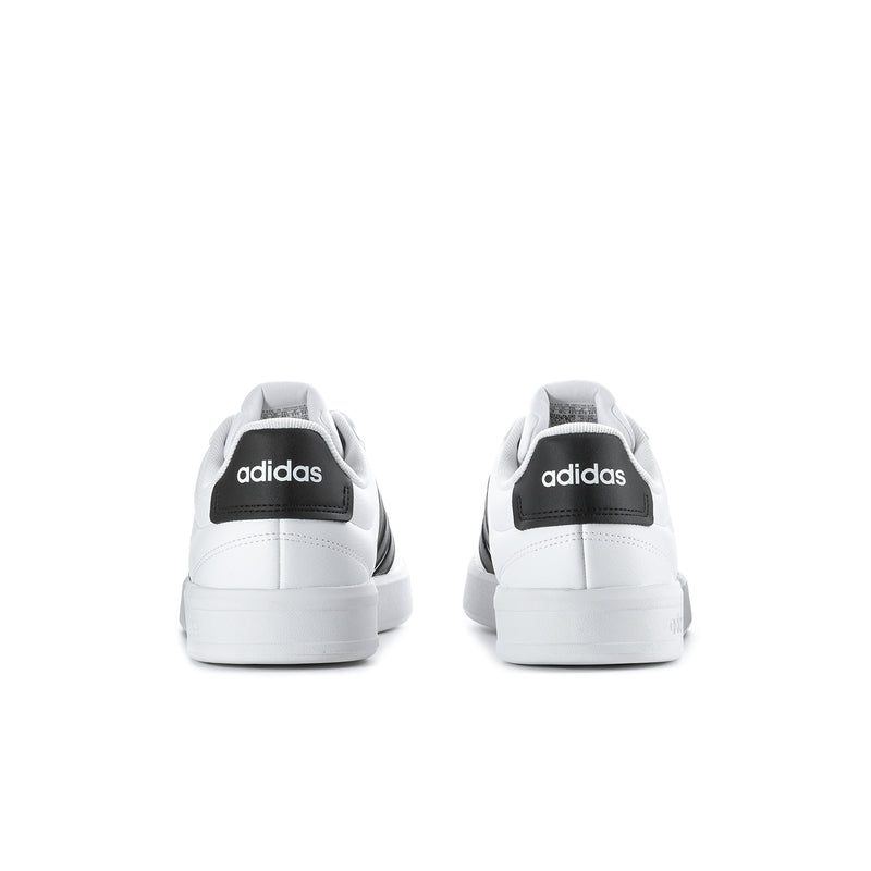 Men's white sneakers with black heel tabs and white rubber soles, back view
