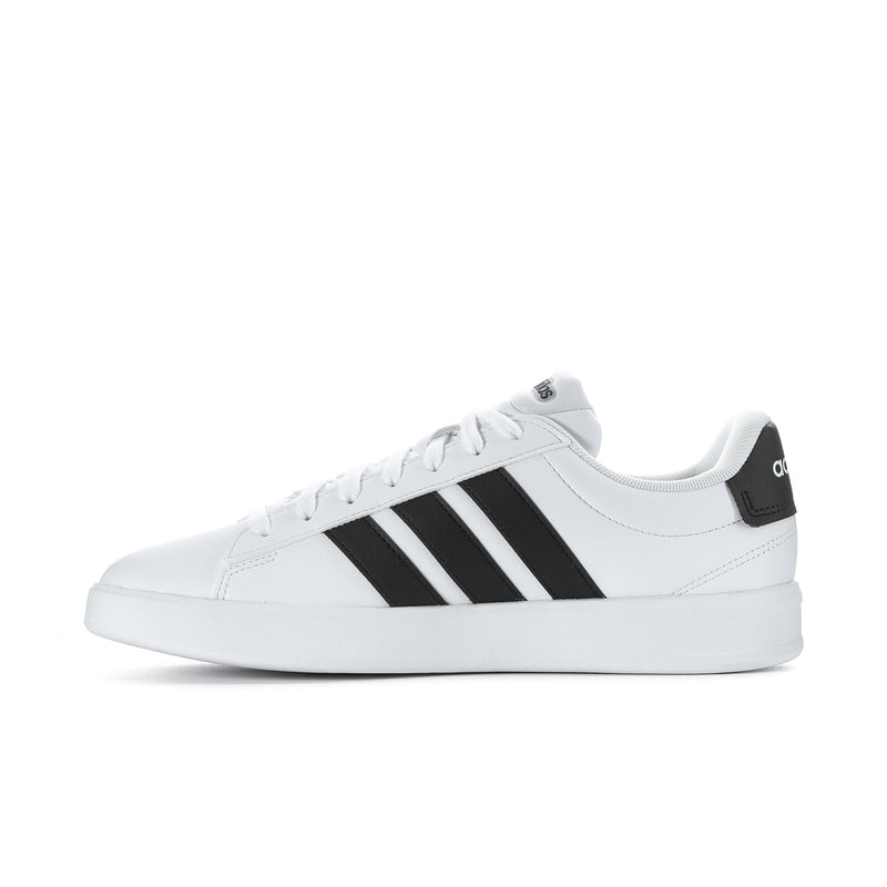 Men's white leather low-top sneakers with black adidas stripes, side profile