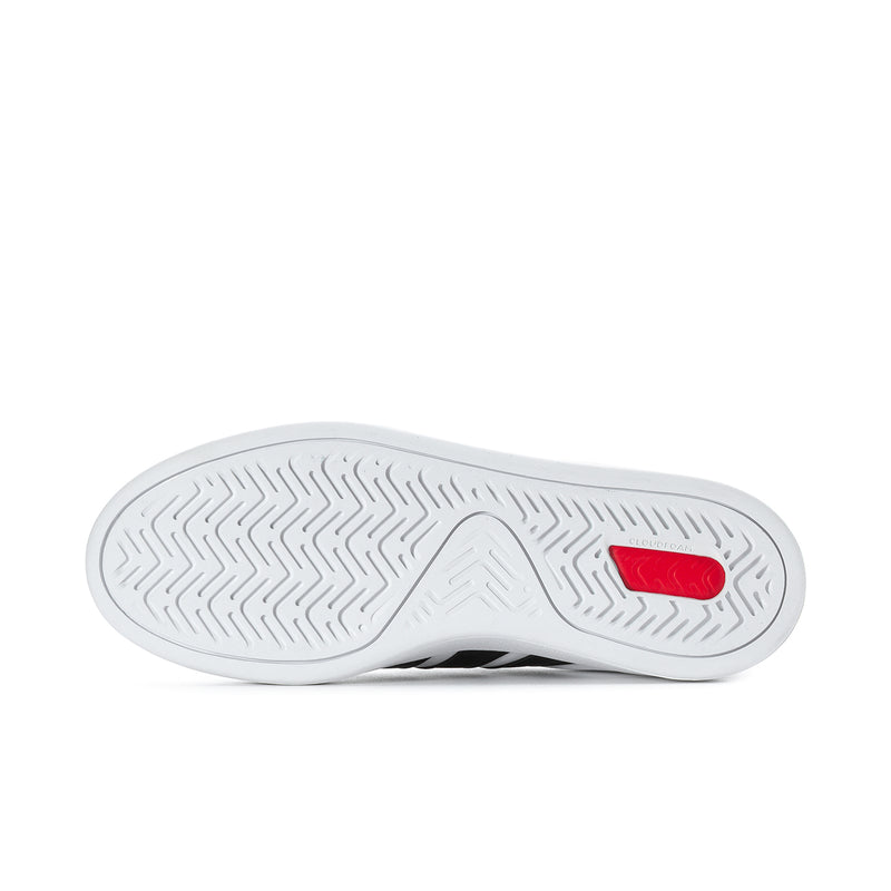 Men's white sneaker outsole with tread pattern and small red heel accent