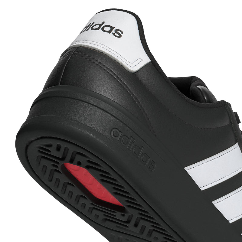 Black adidas sneaker profile with white heel patch and red tread detail