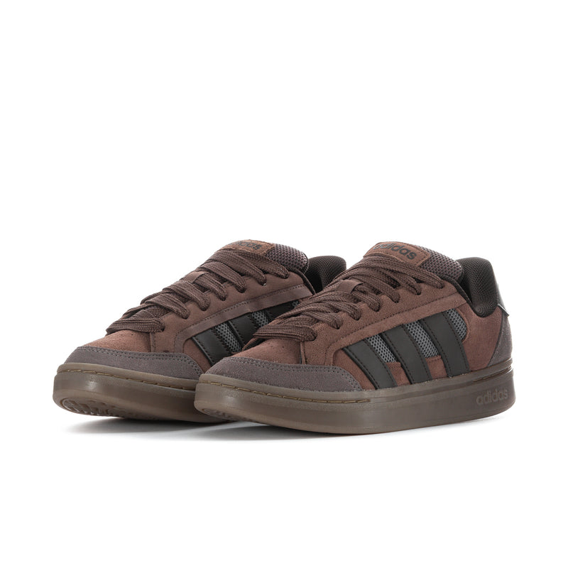 Men's adidas low-top skate sneakers, side view, brown with dark striped panels