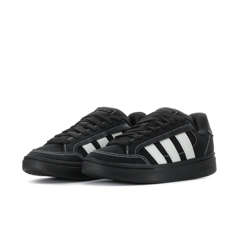 Pair of black low-top sneakers with white triple stripe panels and black laces