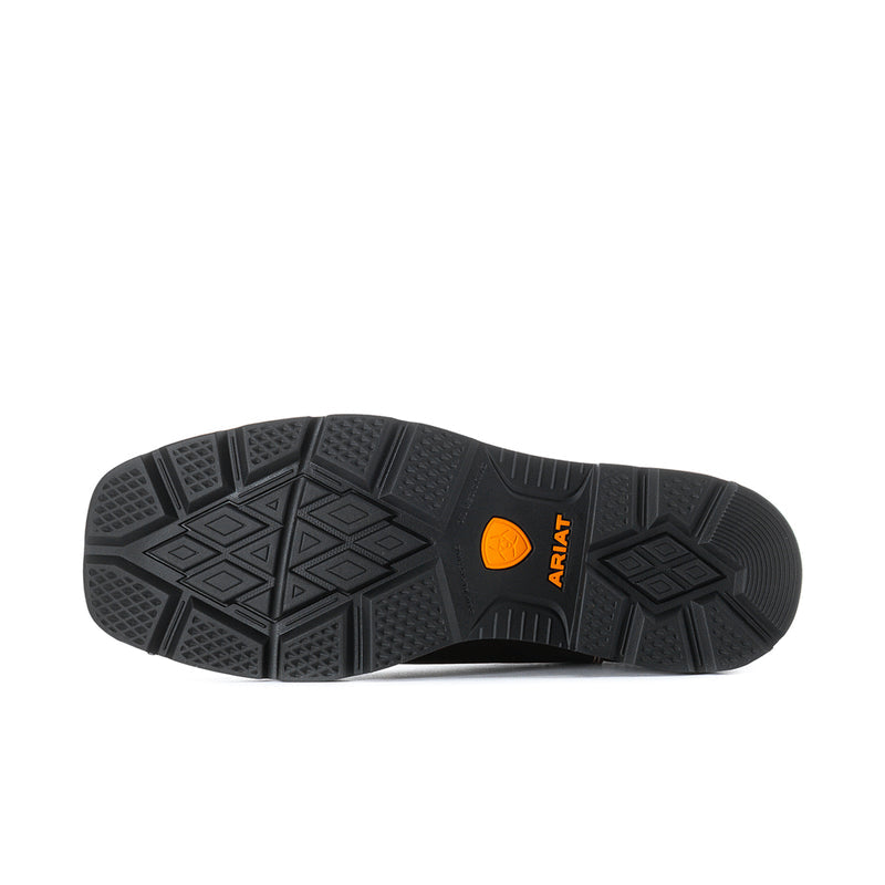 Black rubber outsole with deep tread and orange brand mark