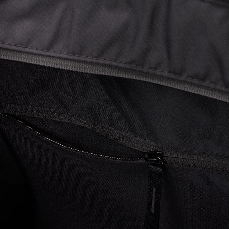 Black gym tote bag close-up of zipper closure on inner pocket