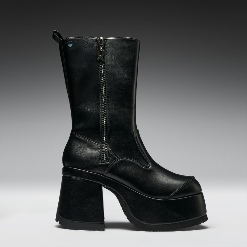 Black leather boot with a platform sole on a gray background