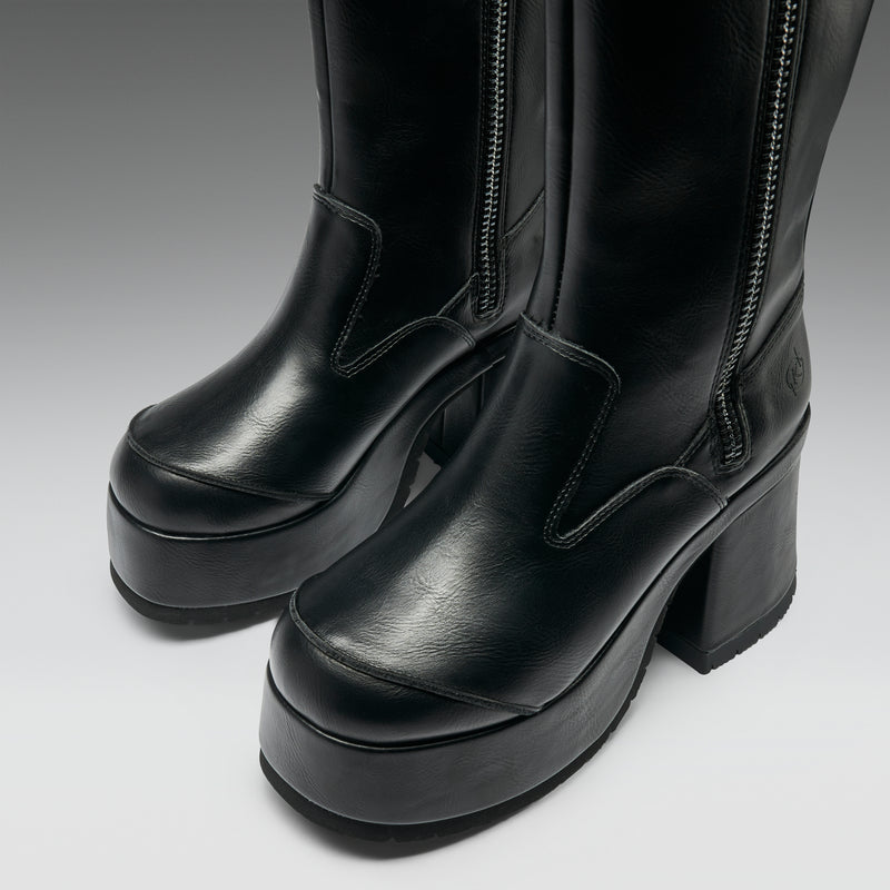 Black platform boots on a light gray background