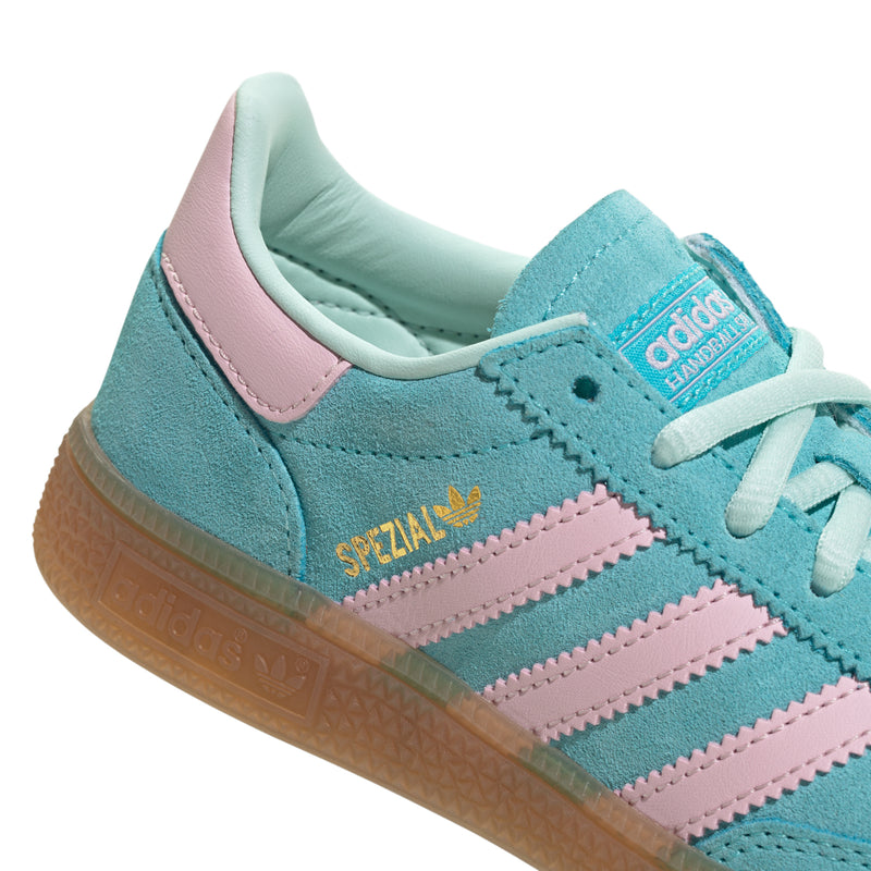 Close-up kids adidas sneaker side, aqua suede with pink stripes and gum outsole
