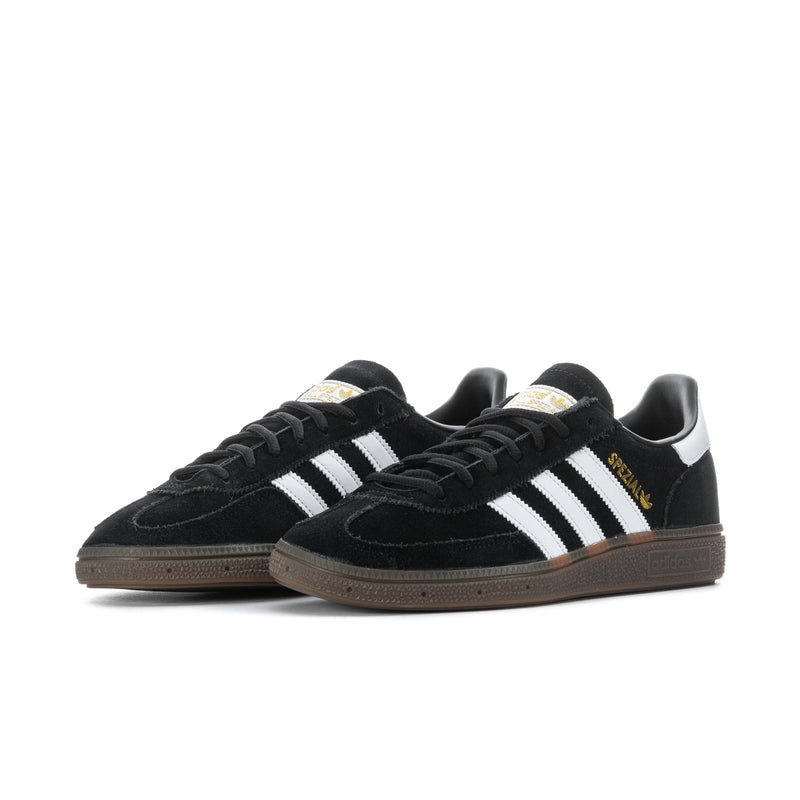 Black suede adidas sneakers with white triple stripes and brown gum sole