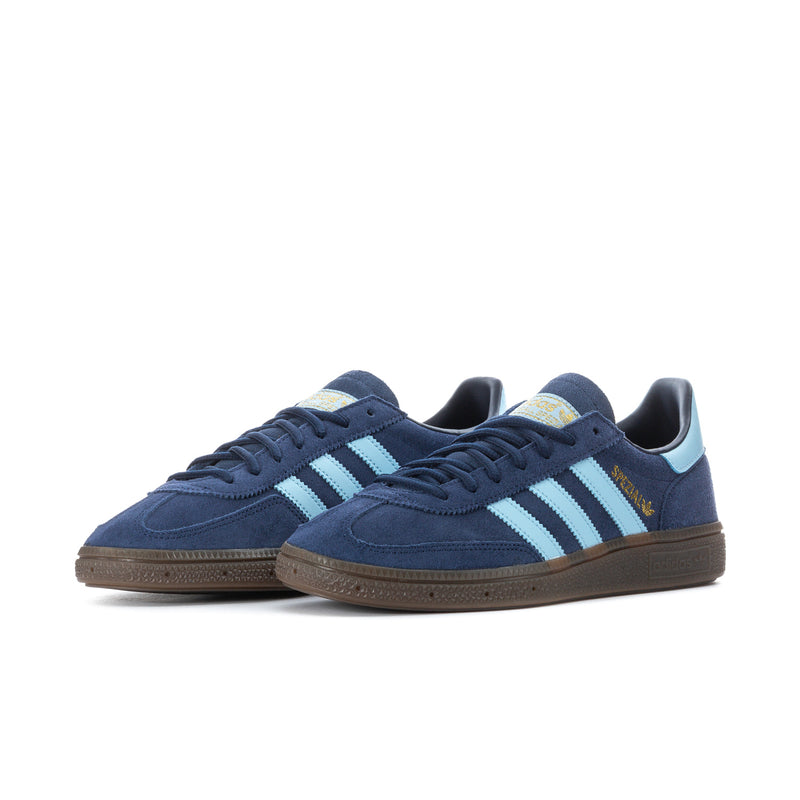 Pair of navy low-top sneakers with light blue stripes, gum sole, lace-up.