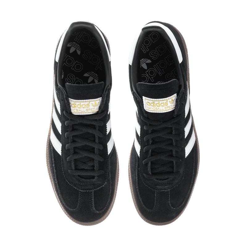 Pair of black low-top sneakers with white accents and lace-up closure