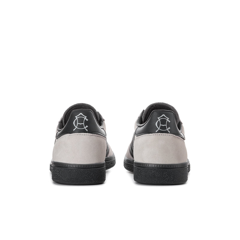 Back view of light gray men's sneakers with black heel and pull tab