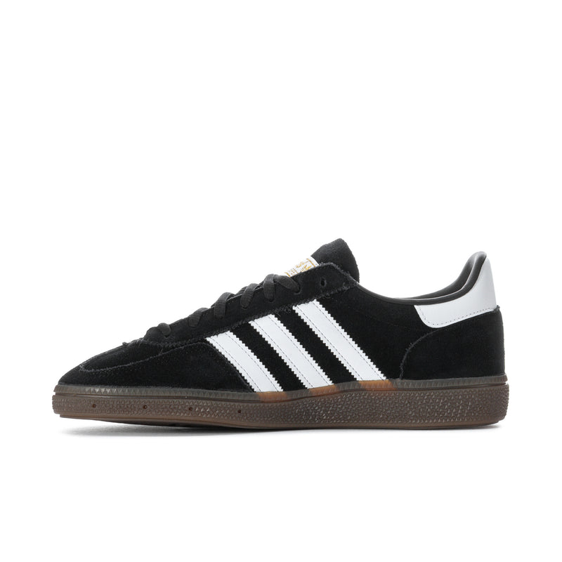 Black low-top sneaker with white triple stripes, gum sole, and lace-up