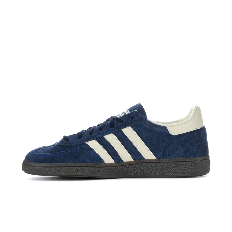 Side profile of men's blue low-top sneakers with cream three stripes
