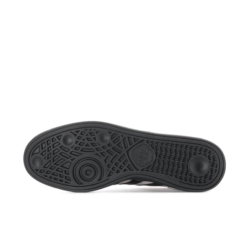 Black rubber outsole with textured tread and circular grip pattern