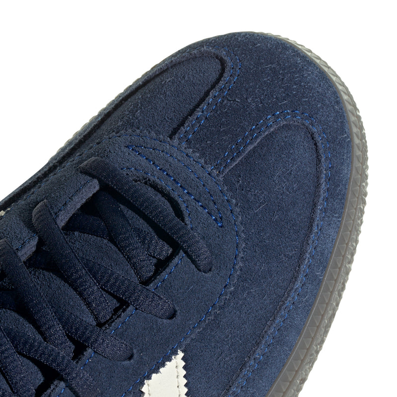 Close-up of blue suede upper with stitched panel and lace holder