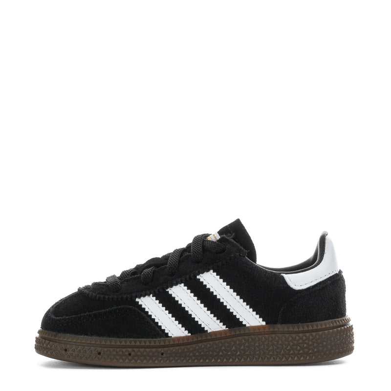 Kids black low-top sneaker with white triple stripes, lace-up closure, and gum outsole.
