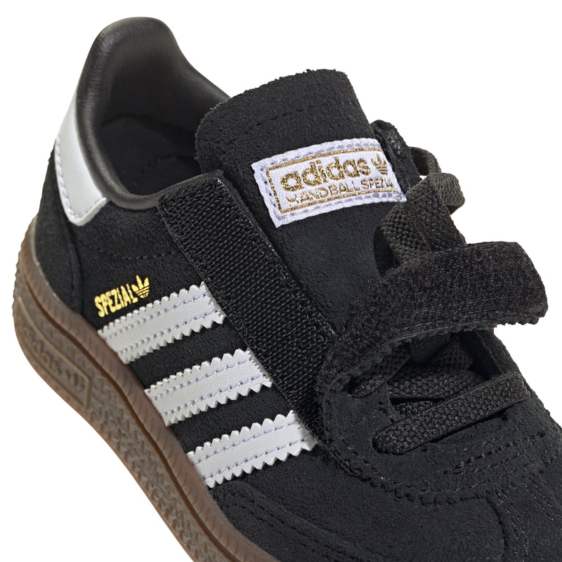 Kids black adidas Handball Spezial sneaker detail: gold “Spezial” label, white stripes, laces.