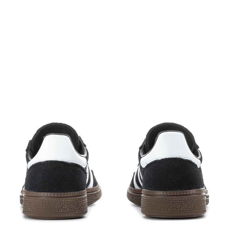 Youth black adidas sneakers with white heel tab and gum rubber sole at back
