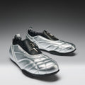 Pair of silver shoes with black accents on a gray background