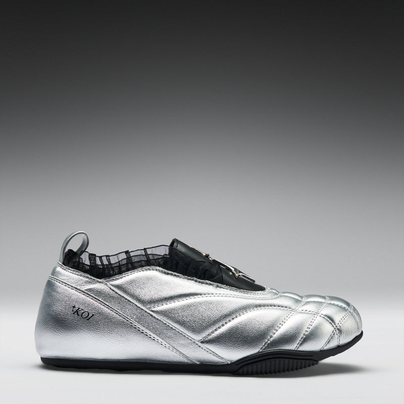 Silver shoe with black accents on a gray background
