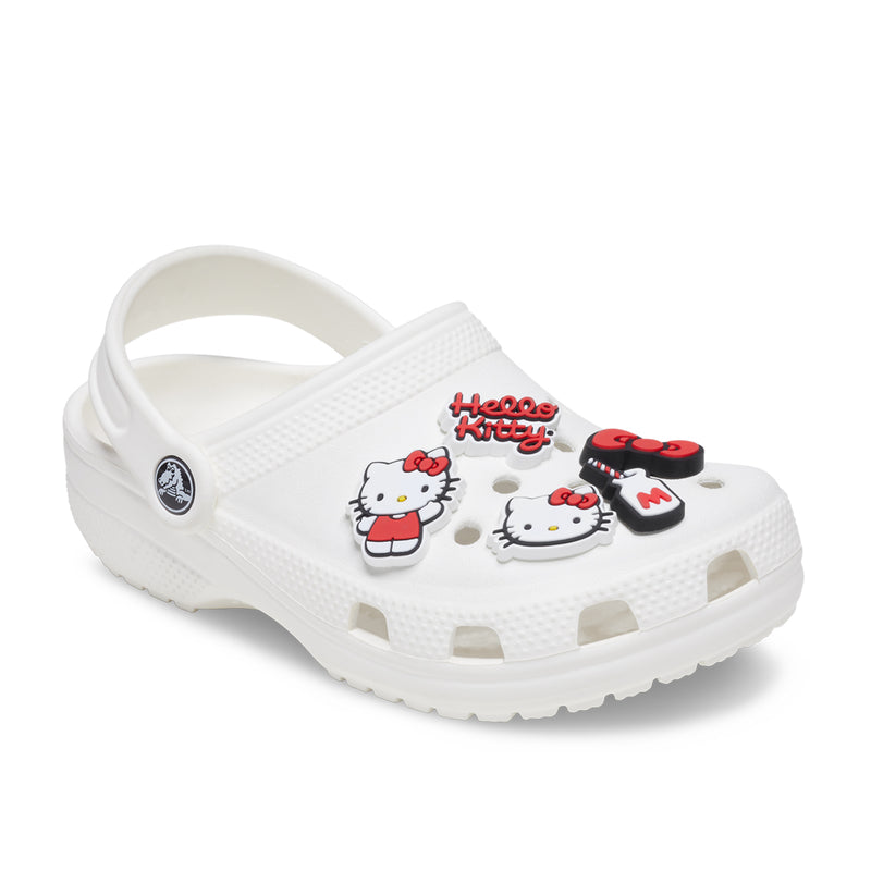 White clog with Hello Kitty Jibbitz charms, red-and-black heart and face designs