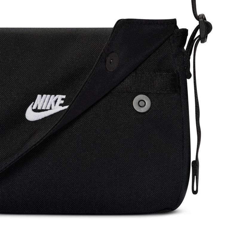 Black textured crossbody bag with Nike logo patch and snap button flap